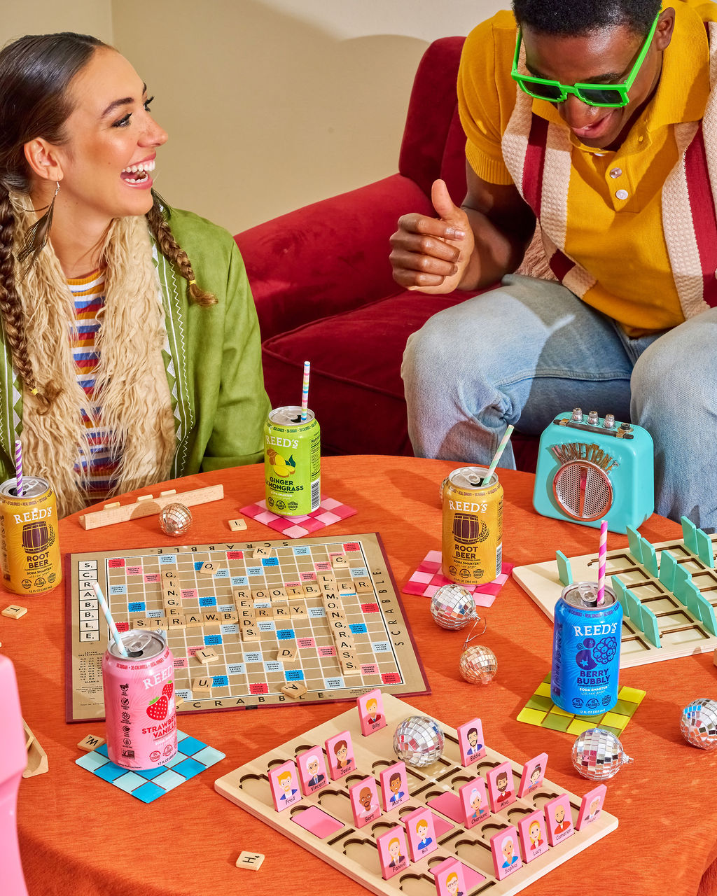 friends playing scrabble while drinking reeds new functional prebiotic and adaptogenic sodas

